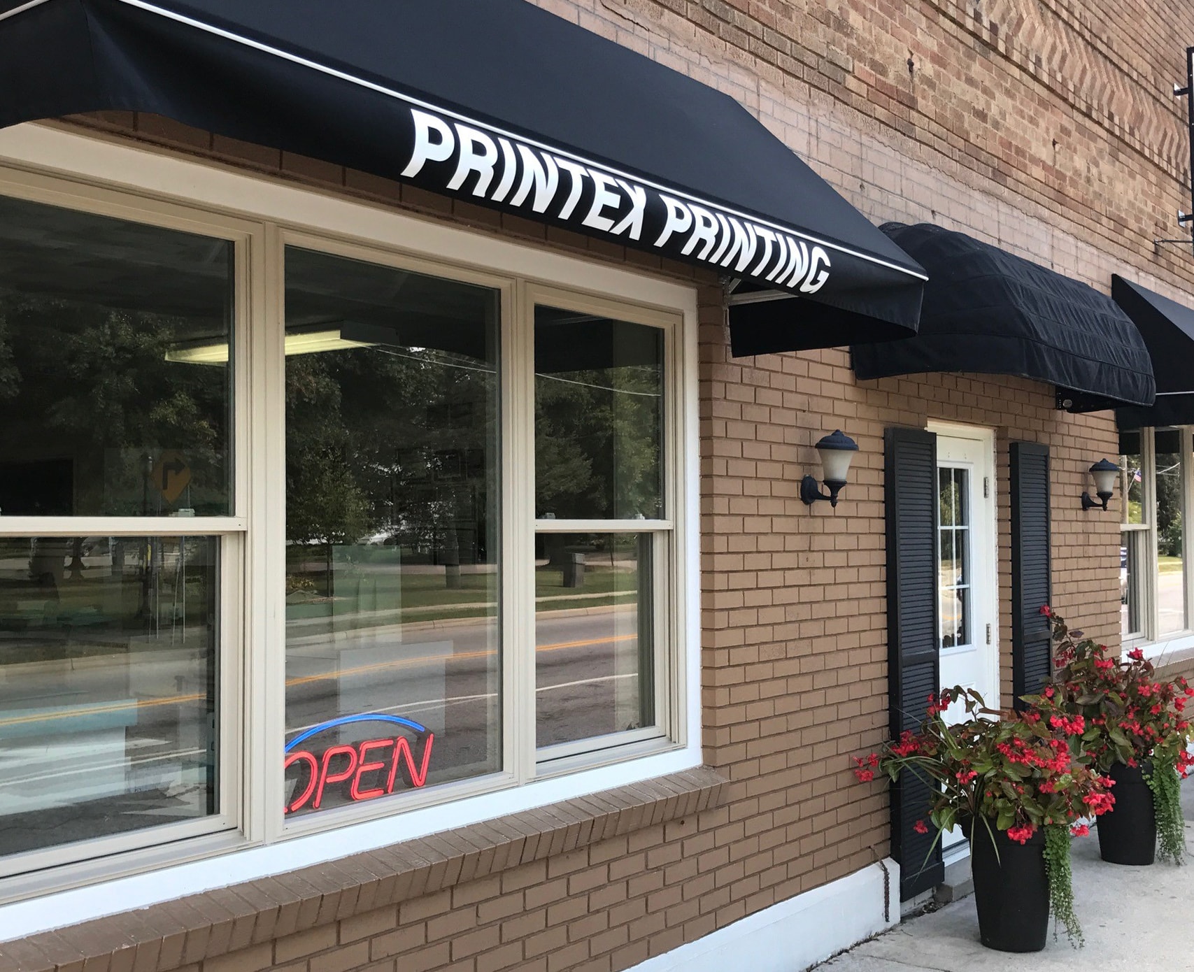 Printex Printing current location in Richland, MI — storefront with black awning